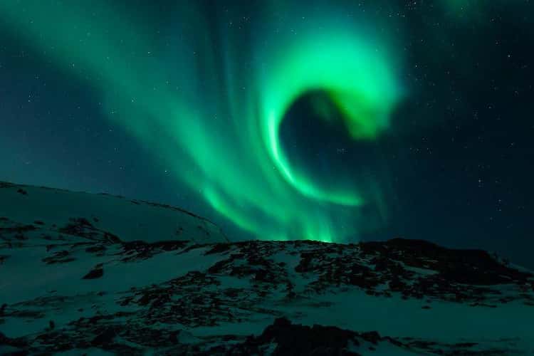 The Aurora Borealis Lights Up The Skies When Particles From The Earth And The Sun's Atmospheres Collide 